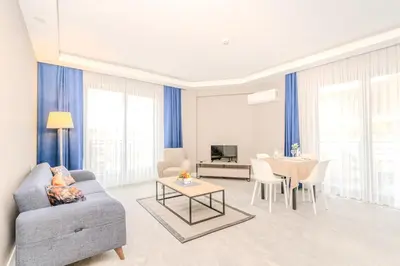 a living room with a couch and a table at Olea Suites Otel in Gemlik