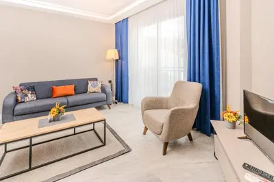 a living room with a couch and a chair at Olea Suites Otel in Gemlik