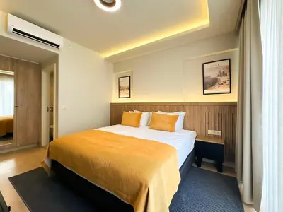 a hotel room with a large bed with orange pillows at Dugi Hotel in Istanbul