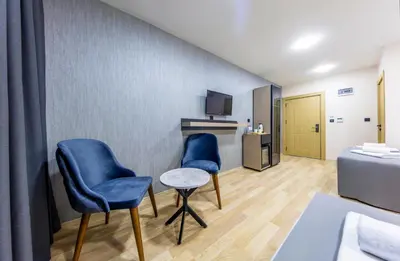 two blue chairs and a table in a room at The Business Class Hotel in Istanbul