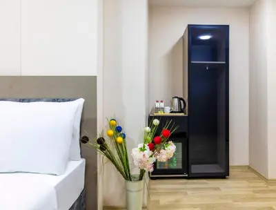 a vase of flowers sitting next to a bed at The Business Class Hotel in Istanbul