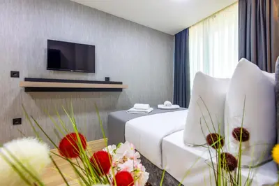 a hotel room with a bed and a flat screen tv at The Business Class Hotel in Istanbul