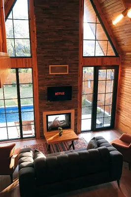 a living room with a couch and a fireplace at Sapanca Grandwooden in Sakarya