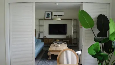 a living room with a blue couch and a table at Mood in Flats in Istanbul