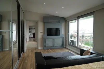 a living room with a couch and a tv at Mood in Flats in Istanbul
