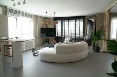 a living room with a white couch and a table at Mood in Flats in Istanbul