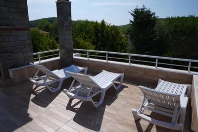a deck with three chairs and a table and chairs at Destina Boutique Hotel Ağva in Sile