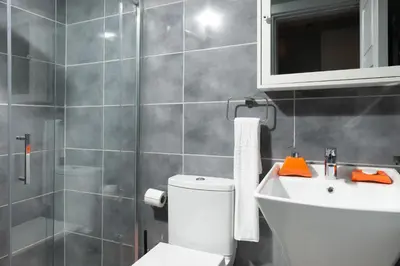 a bathroom with a toilet and a sink and a mirror at G&B MANSION in Istanbul