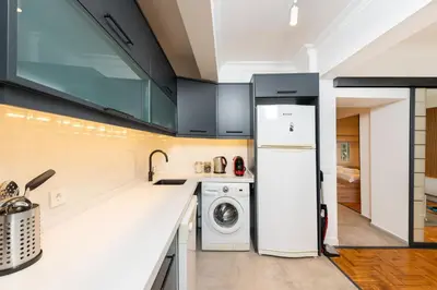 a kitchen with a white refrigerator and a washing machine at G&B MANSION in Istanbul