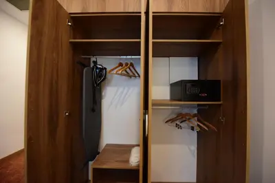 a closet with wooden shelves and a refrigerator at Ramada by Wyndham Karacabey in Bursa