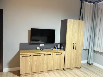 a wooden cabinet with a television on top of it at Taksim Millennium Alkan Residence in Istanbul