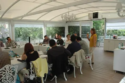 a group of people sitting at tables in a room at Buyukada Cankaya Hotel in Buyukada