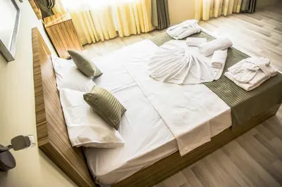 a large bed with white sheets and pillows on it at Berlin Hotel Nisantasi in Istanbul