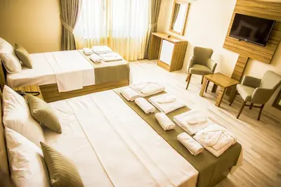 a hotel room with two beds and a television at Berlin Hotel Nisantasi in Istanbul