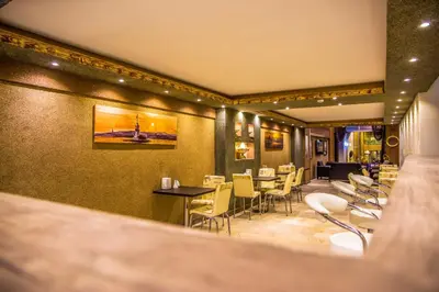 a restaurant with chairs and tables and a bar at Berlin Hotel Nisantasi in Istanbul
