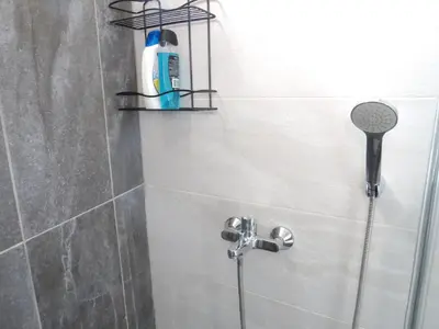 a shower in a bathroom with a shower head at Istanberry - Paradise Two Bedroom Apartments in Istanbul