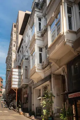 a white building with balconies on a city street at 5 Apartment Galata in Istanbul