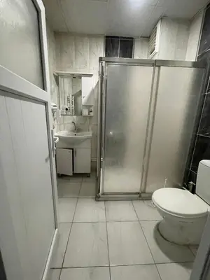a bathroom with a shower and a toilet and a sink at Rosse Hotel in Esenyurt