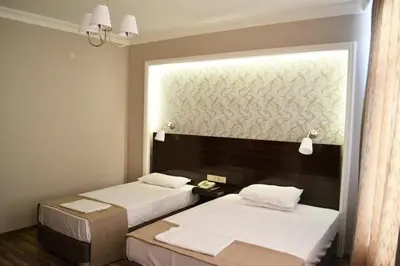 a hotel room with two beds and a window at Venus Hotel Taksim in Istanbul