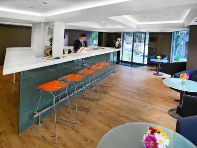 a bar in a restaurant with orange bar stools at Misa Hotel in Istanbul