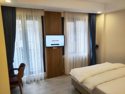 a bedroom with a bed and a flat screen tv at Hotel Esve Istanbul in Istanbul