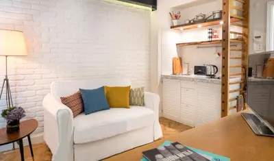 a living room with a white couch and a table at Pera Neuf in Istanbul