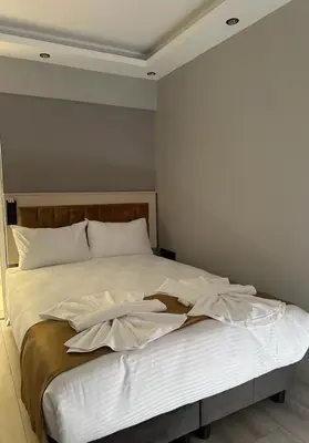 a bed with white sheets and pillows on it at Sareban Hotel Istanbul in Istanbul