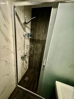 a shower with a glass door in a bathroom at Aram Edessa Hotel in Istanbul
