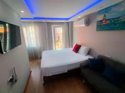 a small bedroom with a bed and a couch at BlueRoyal Grand Bazaar in Istanbul