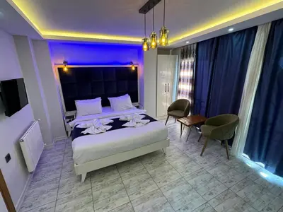 a bedroom with a large bed with purple lighting at GALATAGREENAPPLEHOTEL in Istanbul