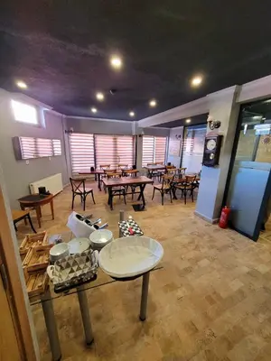 a large room with tables and tables sidx sidx sidx sidx sidx at City Park Suites City Center Corlu in Corlu