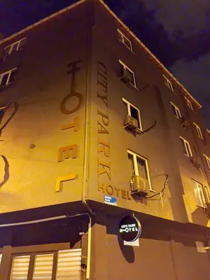 a building with a hotel sign on the side of it at City Park Suites City Center Corlu in Corlu