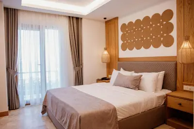 a hotel room with a bed and a window at VillaQua Boutique Hotel in Sile