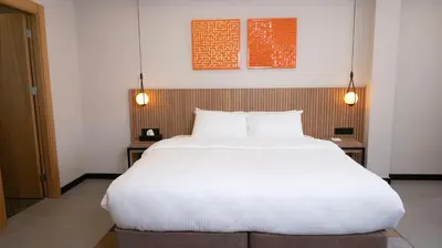 a large white bed in a room with two tables at BeL LETTO HOTEL in Istanbul
