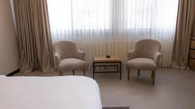 two chairs and a table in front of a window at BeL LETTO HOTEL in Istanbul