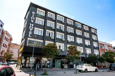 a black building with a sign on the side of it at Rio's Hotel AİRPORT in Istanbul