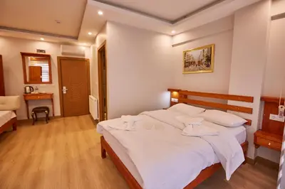 a bedroom with a large white bed with white sheets at Sabina Hotel near Grand Bazaar, city center in Istanbul