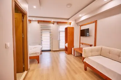 a living room with a couch and a bedroom at Sabina Hotel near Grand Bazaar, city center in Istanbul