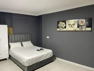 a bedroom with a bed with white sheets at Rena Apart Hotel in Istanbul