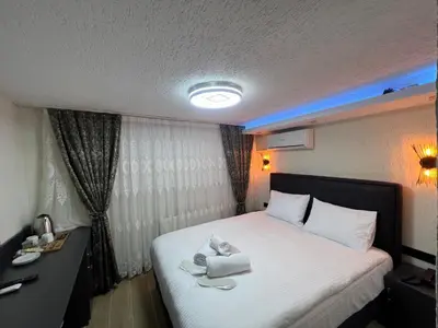 a hotel room with a bed with towels on it at Feycem Suites Hotel in Istanbul