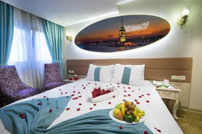 a hotel room with a bed with a plate of fruit on it at Parmada Hotel in Istanbul