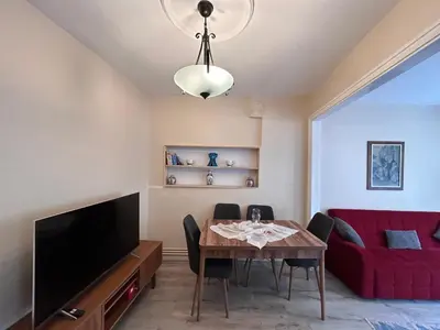 a living room with a table and a red couch at 1001 Boutique House in Istanbul