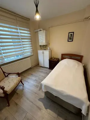 a bedroom with a bed and a small refrigerator at 1001 Boutique House in Istanbul
