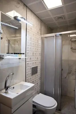 a bathroom with a toilet and a sink and a shower at SULTAN SÜLEYMAN APART HOTEL in Istanbul