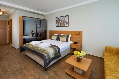 a hotel room with a bed and a couch at Hattusa Vacation Business Thermal Hotel Saray in Saray