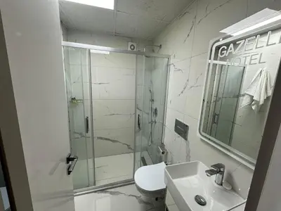 a bathroom with a shower and a toilet and a sink at gazelle suites in Istanbul