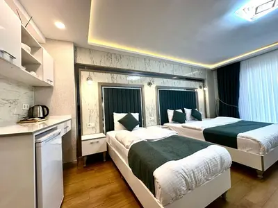 a hotel room with two beds and a kitchen at gazelle suites in Istanbul