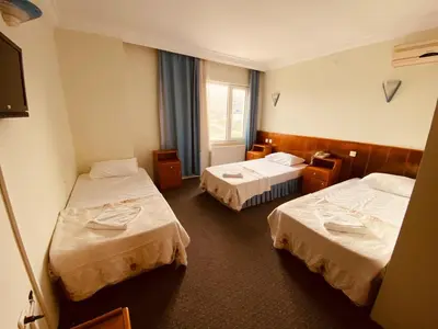 a hotel room with two beds and a television at SANCAK HOTEL in Buyukcekmece