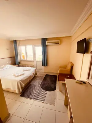 a hotel room with a bed and a desk at SANCAK HOTEL in Buyukcekmece