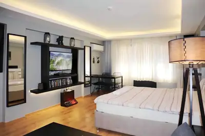 a bedroom with a bed and a flat screen tv at HANDMADE in Istanbul